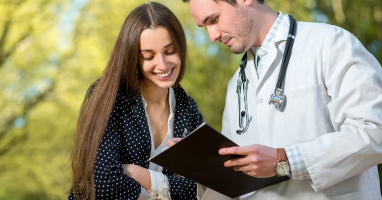 A Young Lady Discussing Something with Her Doctor - Thors Therapy