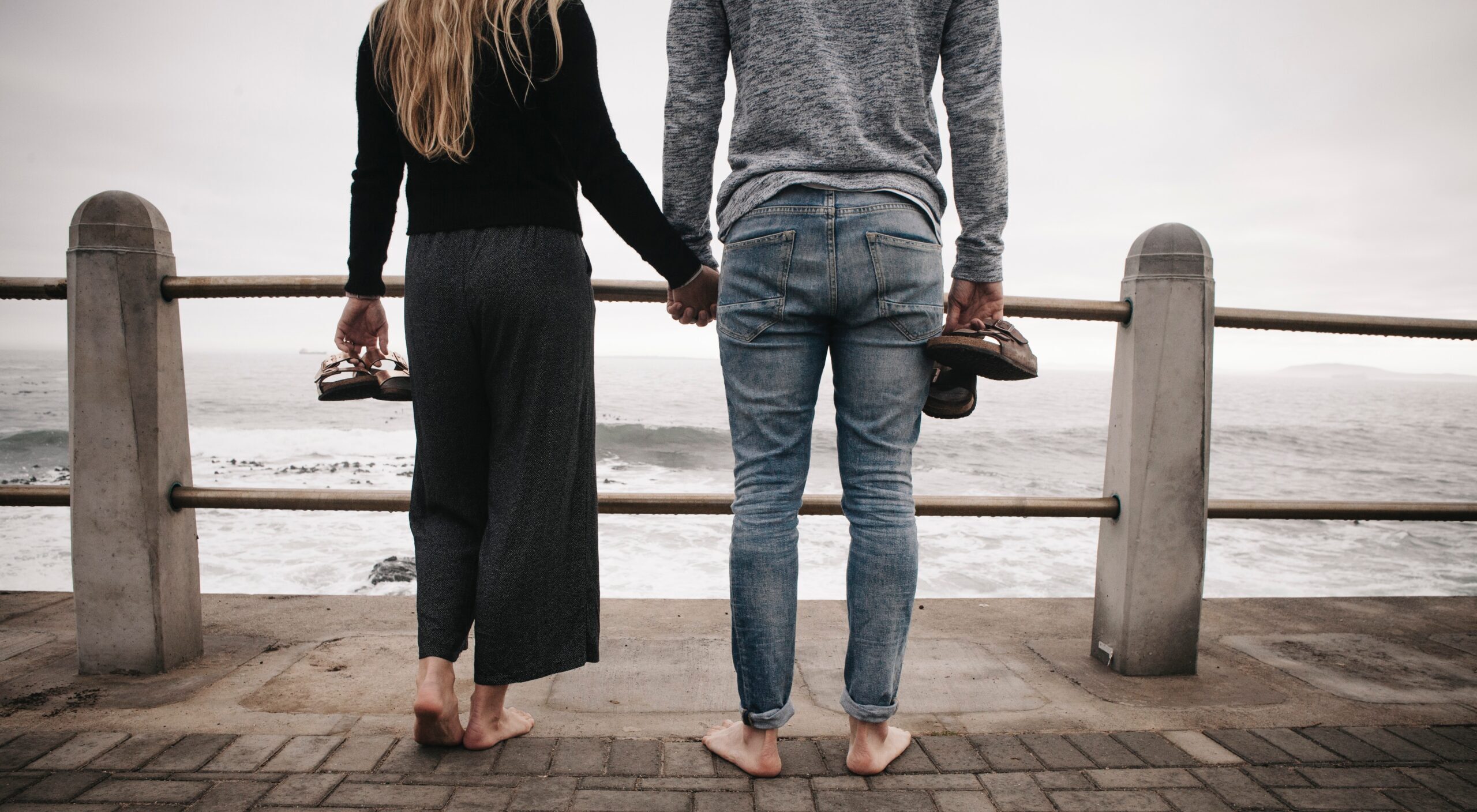 A Couple Holding Hands Near a Bridge- Thors Therapy