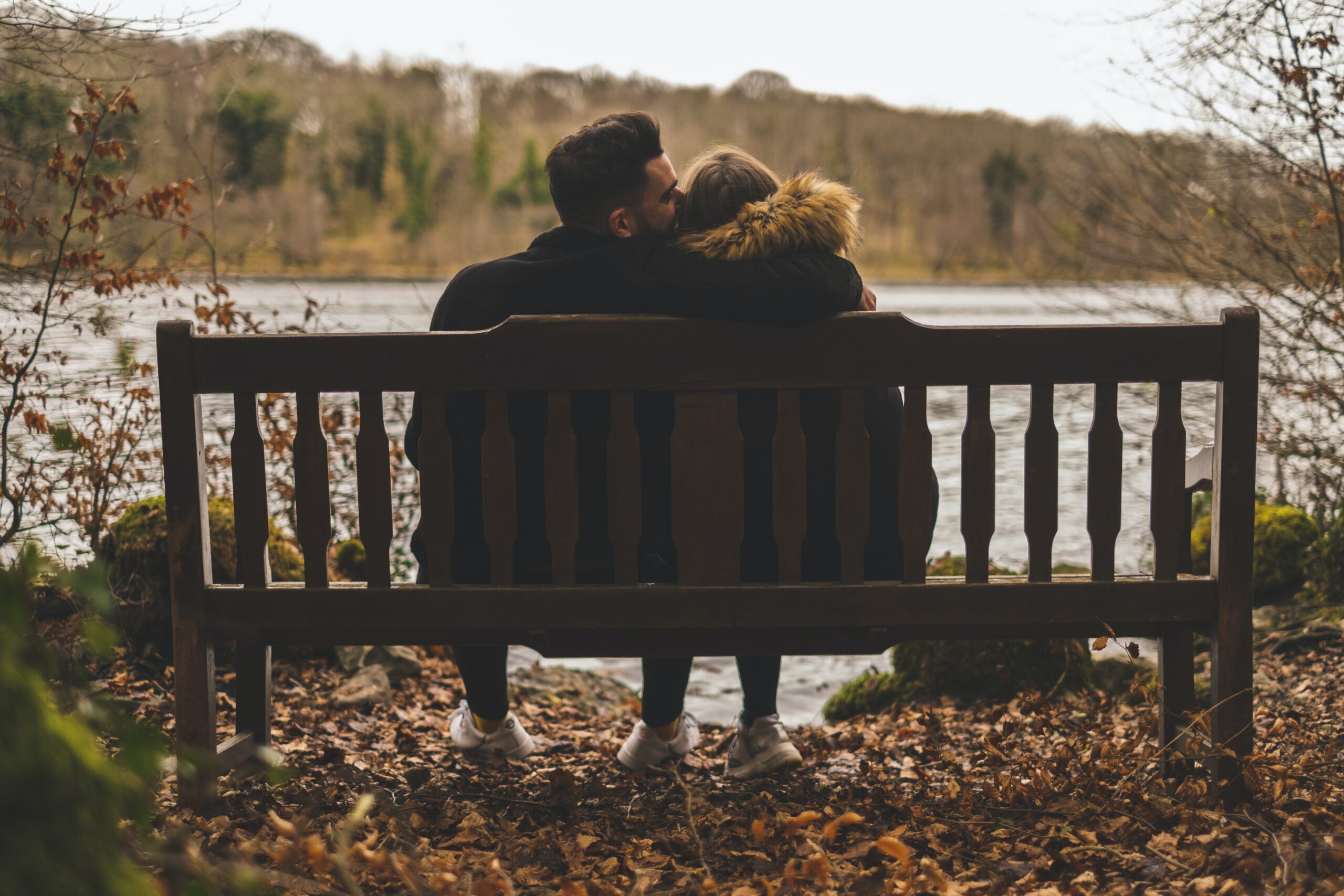 A couple sitting on a park bench