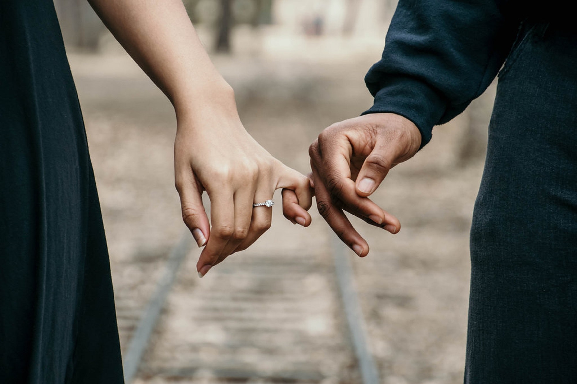 Couples locking fingers together