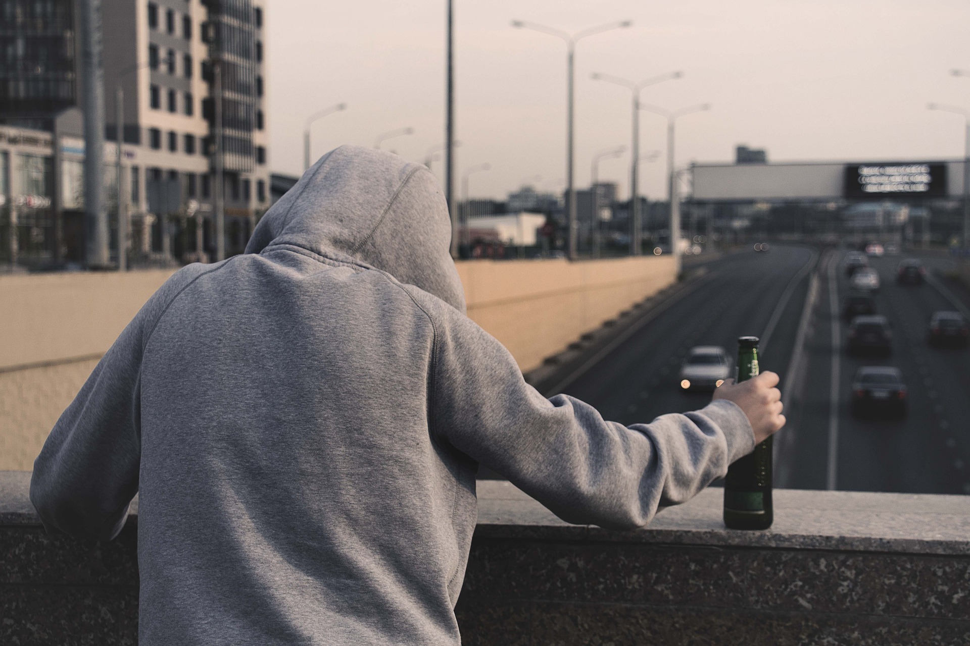 An alcohol addict holding a bottle 