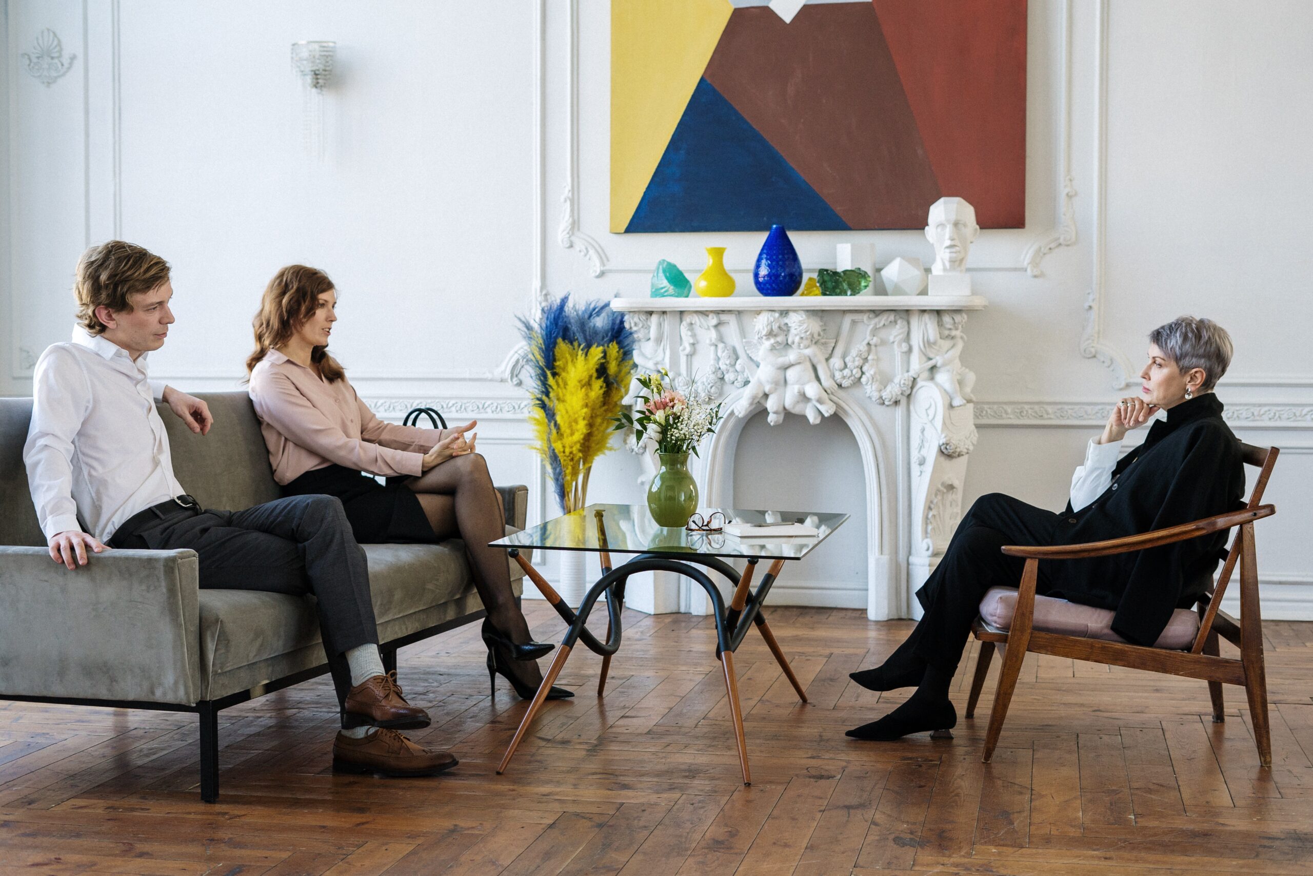 A couple sitting with their therapist