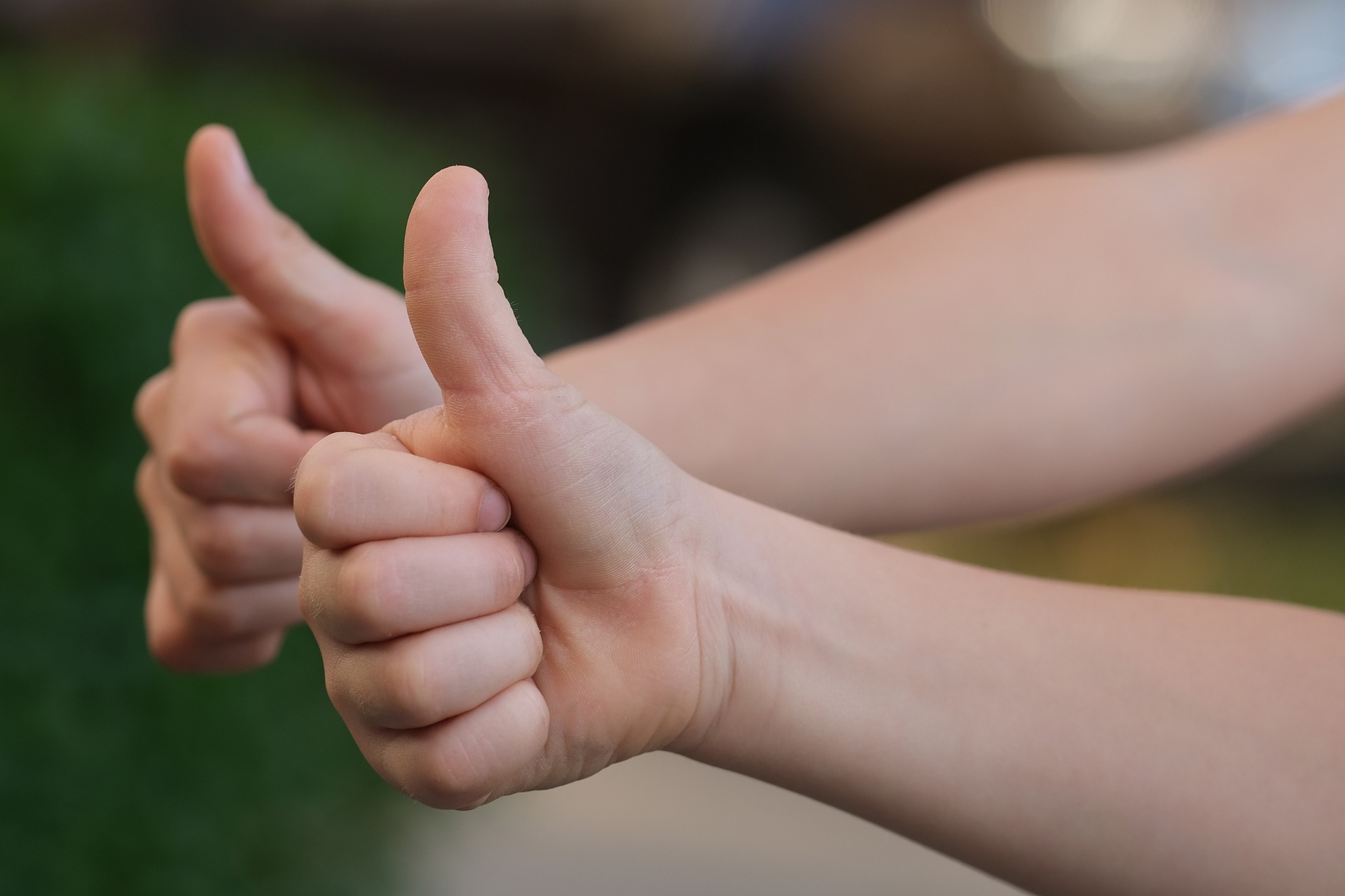 Two people doing thumbs up