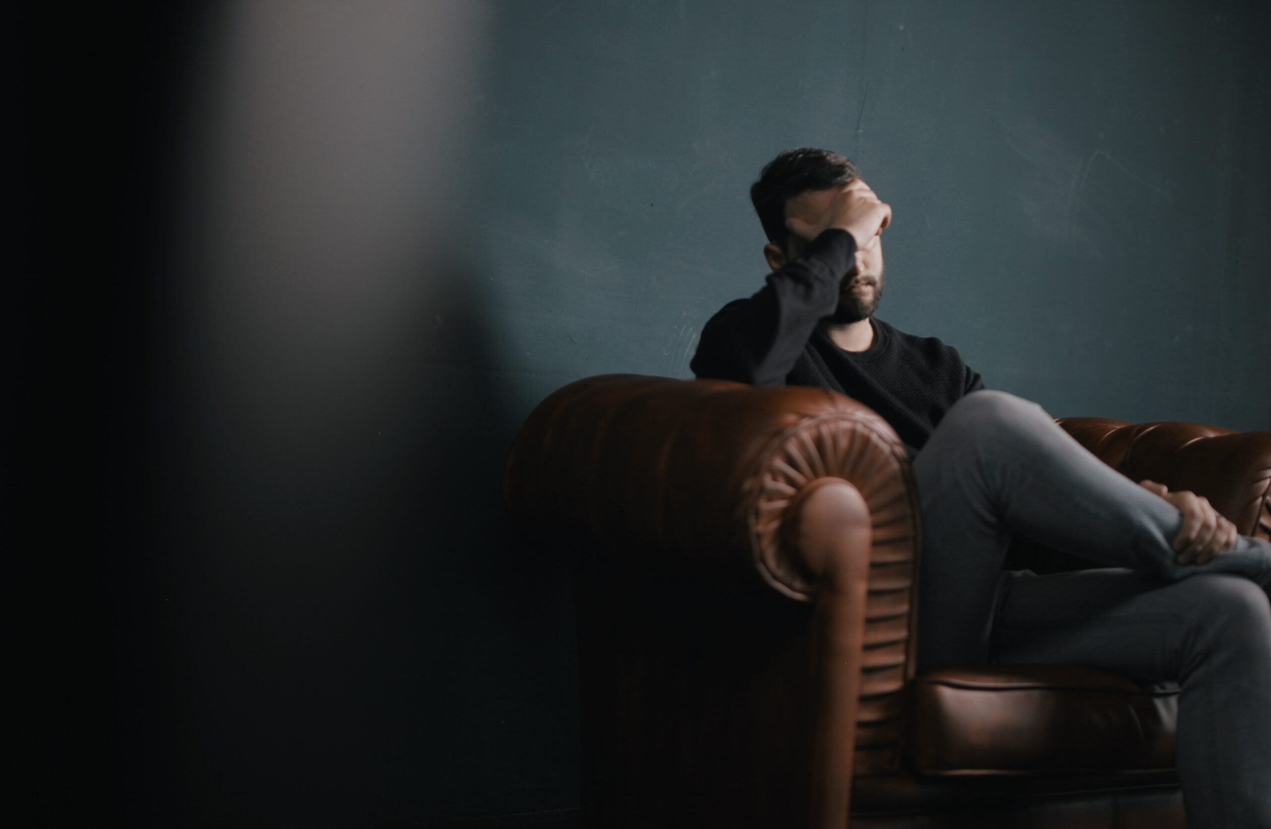 A man thinking on the couch