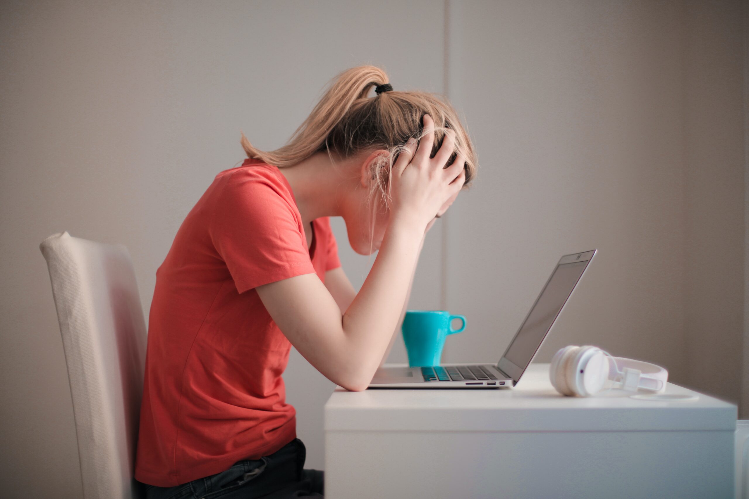 A woman sitting at a table with her laptop