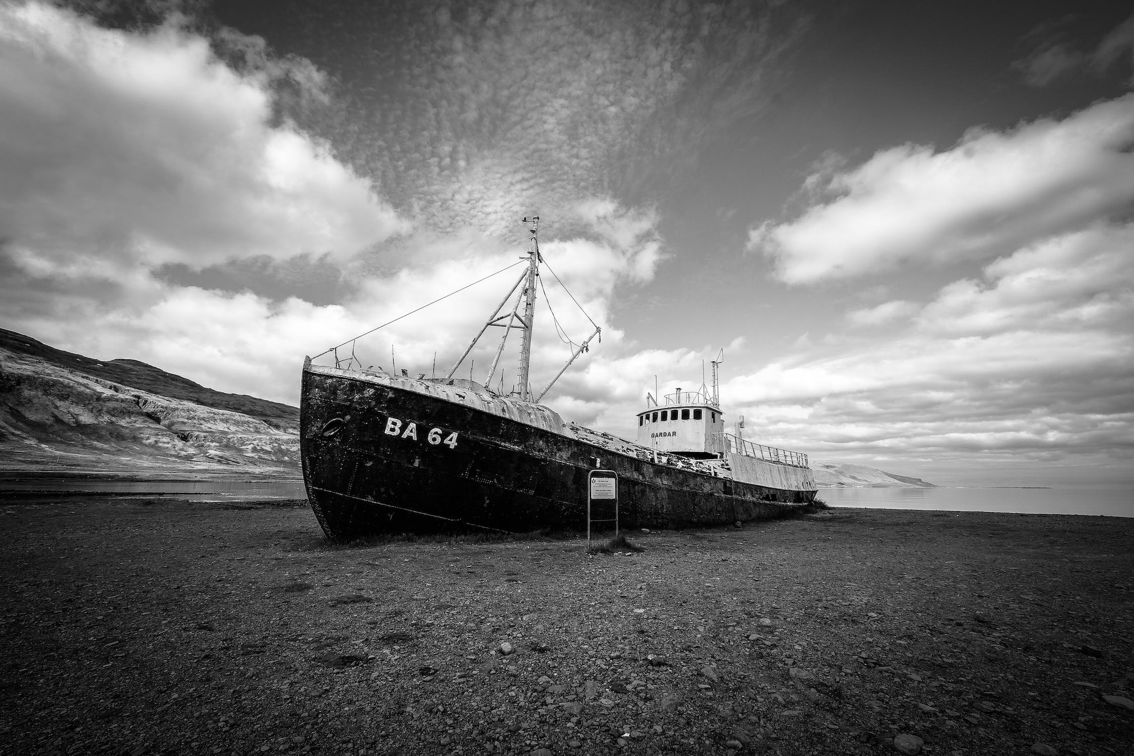 a boat sitting on top of a dry grass field